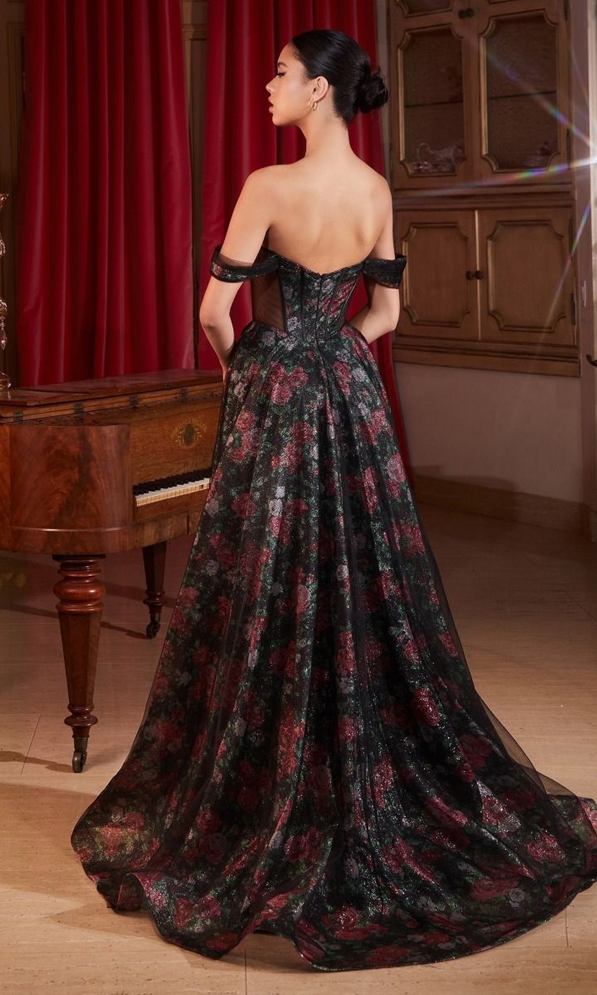 A woman stands indoors with her back to the camera, wearing the Off-Shoulder Long Floral-Print Prom Dress CD806—an elegant a-line gown with a stunning train.